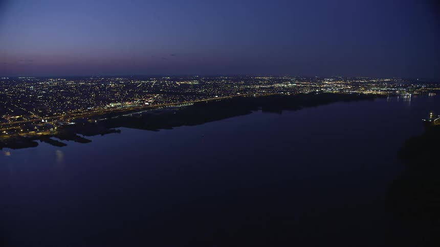 Aerial footage over Delaware River and North Philadelphias city lights at night during summer