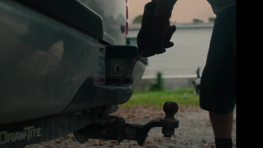 A man tighting a bolt on a car