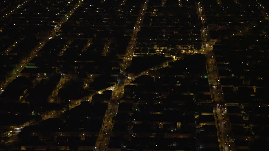 Aerial footage of urban residential neighborhoods and city streets in South Philadelphia at night