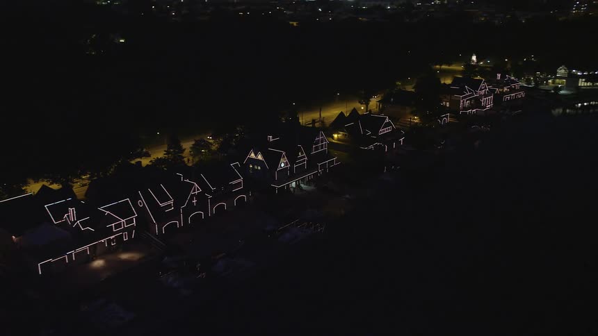 Aerial footage of Boathouse Row lit up at night in Philadelphias historic neighborhood