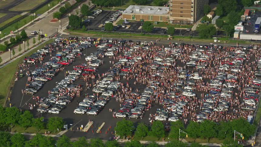 An aerial view of a large crowd of people gathered in a parking lot near Campbells Field Camden New Jersey