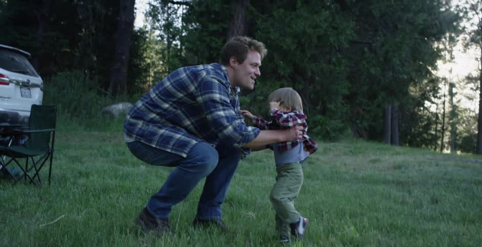A father throws his son up in the air