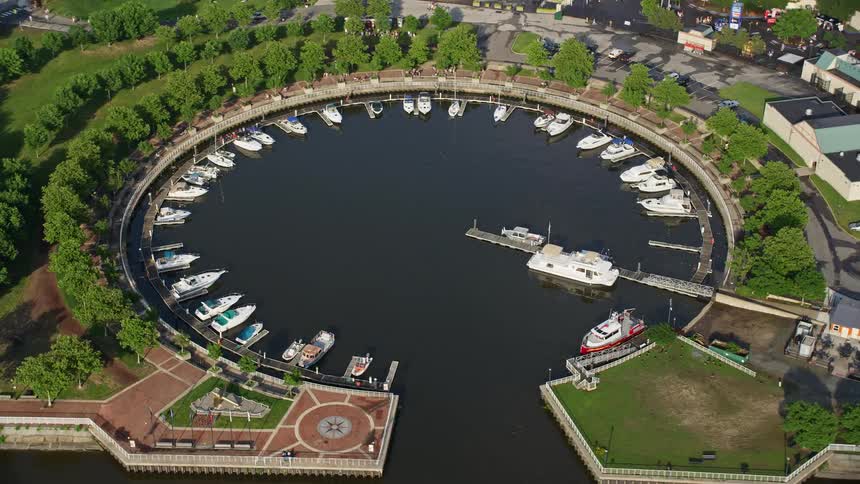 Aerial footage of docked boats at Wiggins Marina in Camden New Jersey on a sunny day