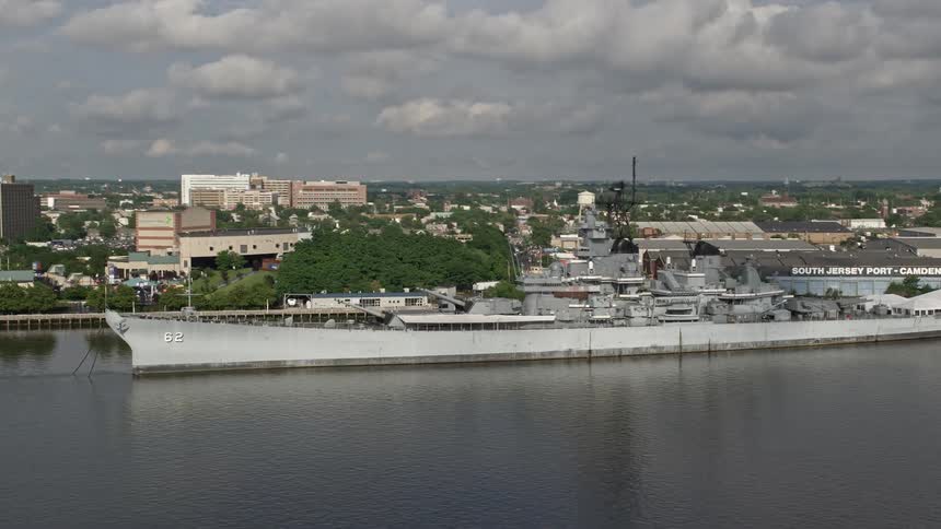 Aerial footage of USS New Jersey passing through Camdens Balzano Marine Terminal during the summer