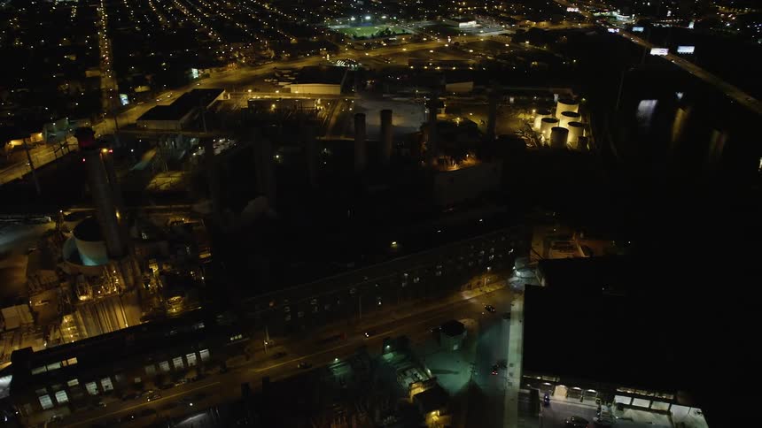 Aerial footage of Veolia Energy power plant in South Philadelphia at night showing smoke stacks and industrial manufacturing