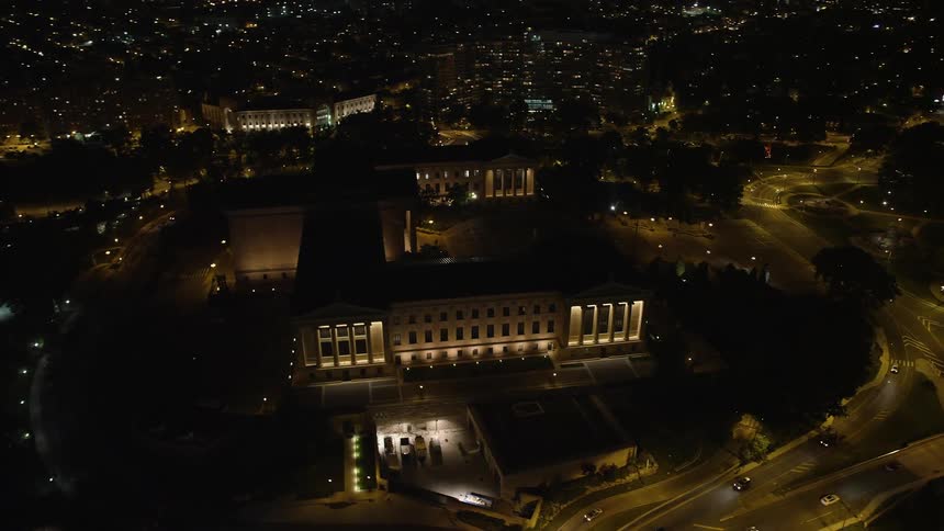 An aerial view of the Philadelphia Museum of Art and illuminated skyscrapers at night in Pennsylvania