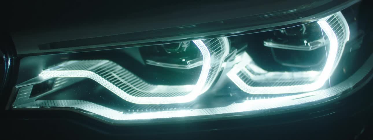 Curved translucent shapes shine brightly on machine structure