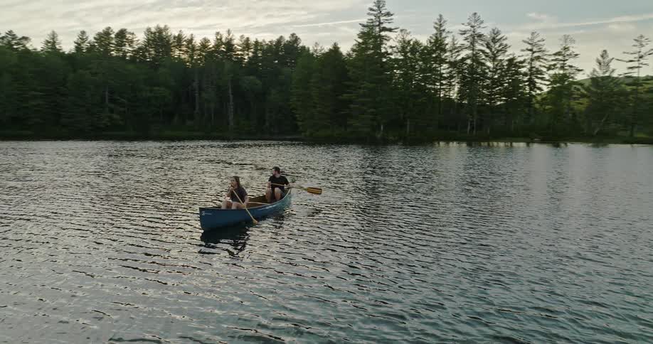 Two people row a boat in the lake