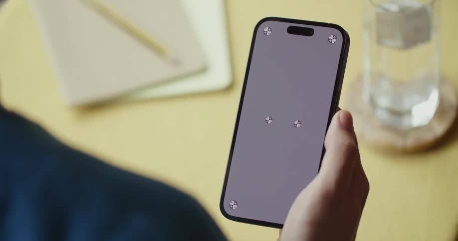 A person uses their thumb to scroll on the screen of a smartphone