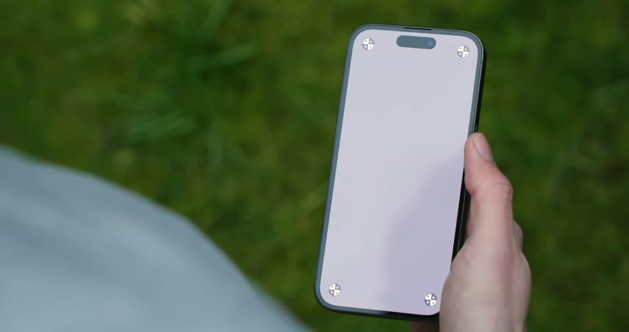 A man scrolls through his phone with his thumb