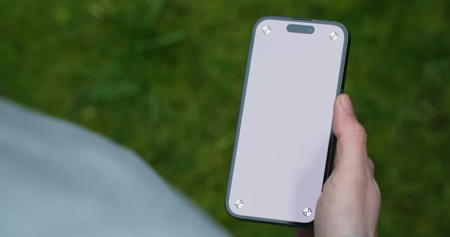 A womans hand is holding a cell phone and scrolling through a blank screen with her thumb