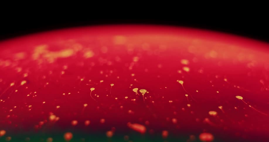 Fluorescent colors stretch and move as they blend as particles float across the surface of the sphere
