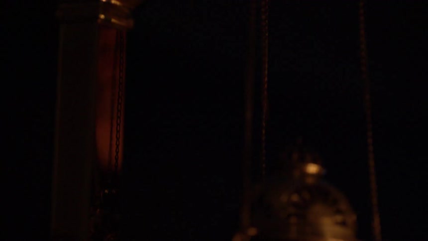 Firelight reflects on a hanging censer