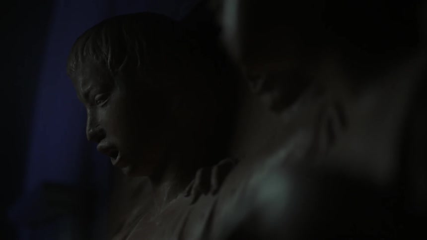 A carving of a screaming person