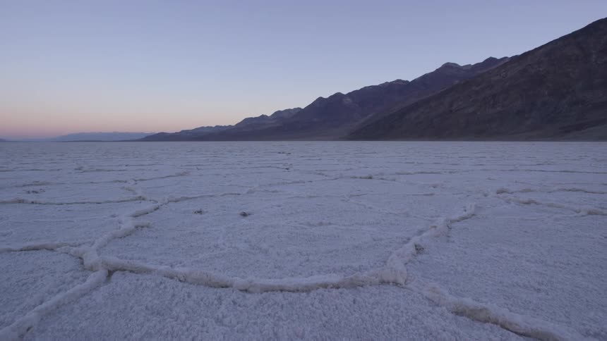 A field leads to a mountain at dawn