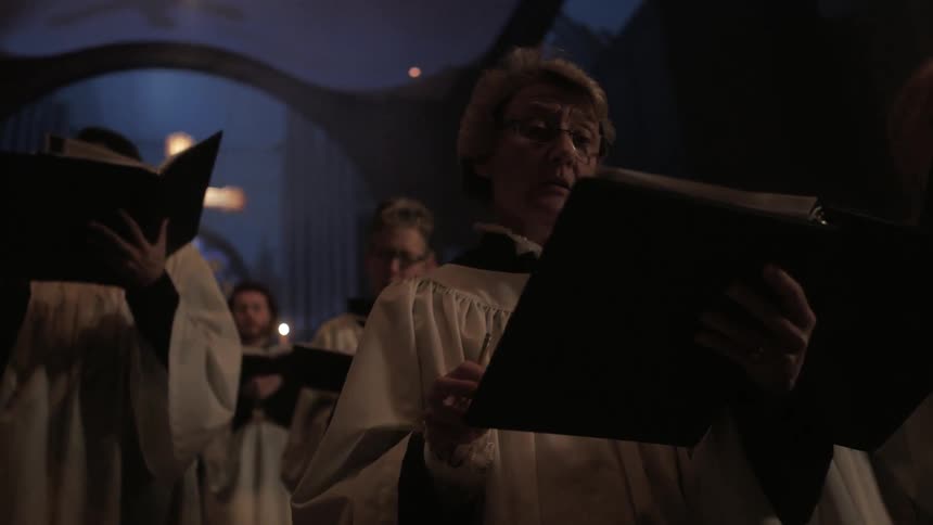 A choir performing during a candlelight service