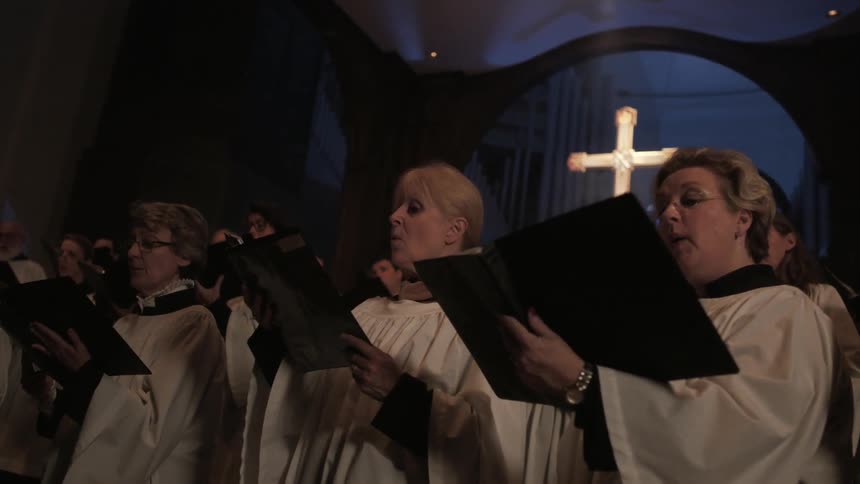 Congregation of people singing from their books