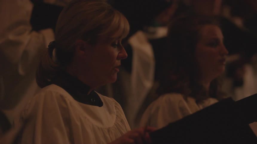 A woman sings in a choir