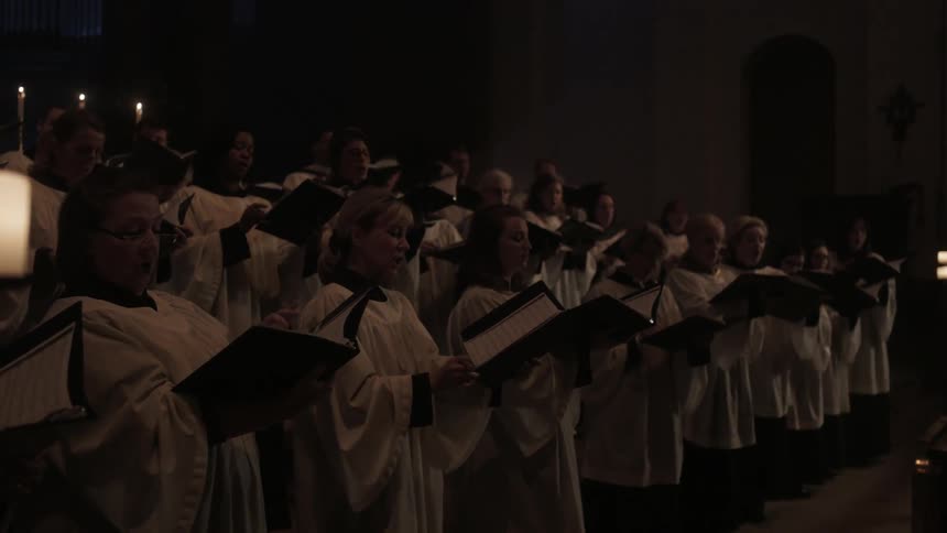 A choir performing by candlelight