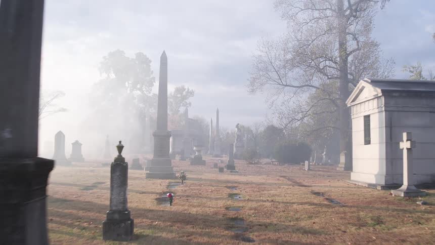 A foggy cemetery during the day
