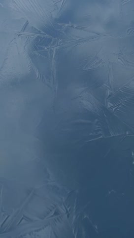 Cracks form in ice on the surface of a lake
