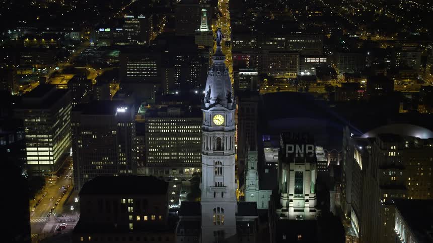 Approaching Philadelphia City Hall at night from an aerial view and tilting to a birds eye view