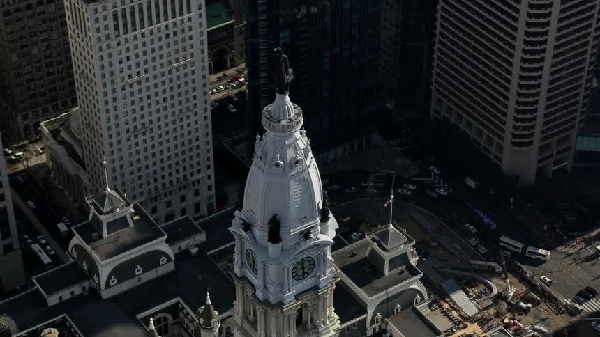 Fly around William Penn statue on Philadelphia City Hall in aerial footage