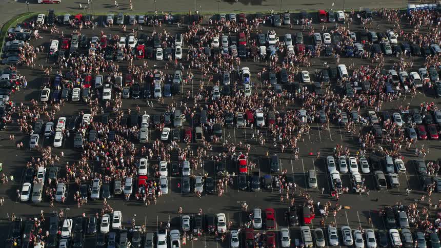 Aerial footage of tailgating crowds gathering in a parking lot at Campbells Field in Camden New Jersey during a sunny day