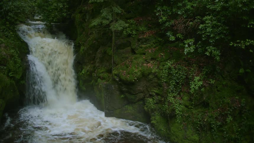 Small water flowing flowing into a pool of water