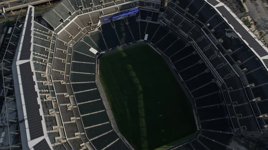 An aerial view of a large sports stadium in a city