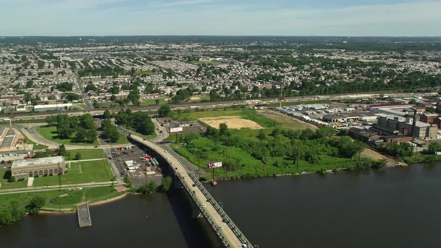 An aerial view of factories and industrial buildings surrounding the Tacony Palmyra Bridge in Philadelphia