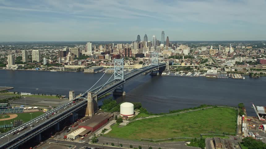 An aerial view of the Benjamin Franklin Bridge spanning the Delaware River near Downtown Philadelphias skyline during the daytime