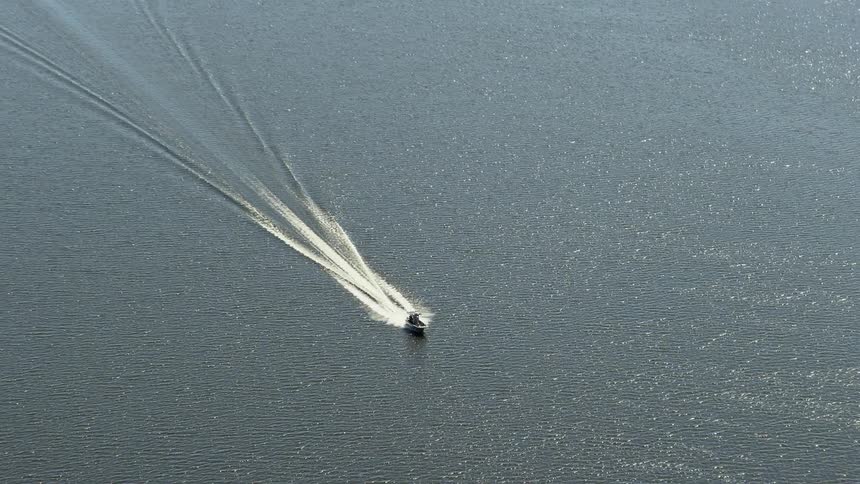 A fishing boat glides along the Delaware River caught in stunning aerial stock footage