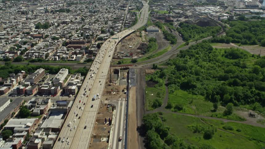 An aerial view of light traffic on interstate 95 reveals the industrial buildings in North Philadelphia