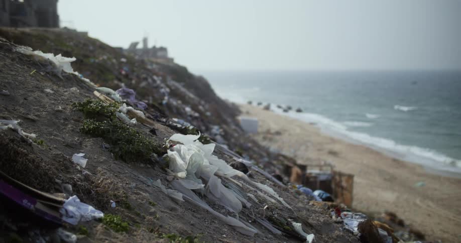 Trash and litter cover slope overlooking beach