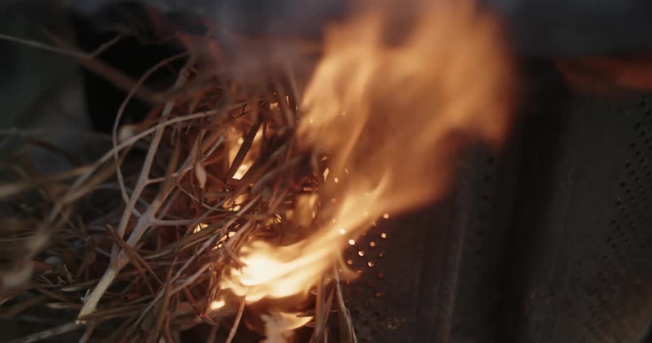 Flames are rising as fire is burning dry weeds