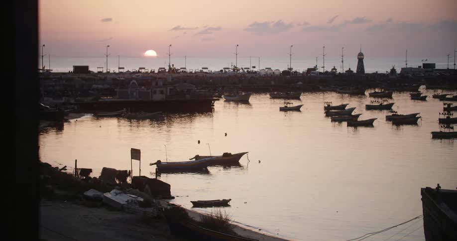 Small wooden boats sit anchored in the water