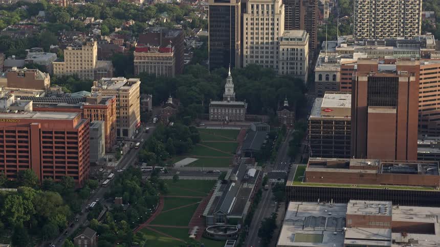 A breathtaking aerial view of Independence Hall at dusk seen across Independence Mall in Downtown Philadelphia Pennsylvania at sunset amidst clear skies and perfect weather conditions
