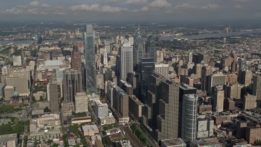 A aerial video shows Philadelphias downtown area with towering buildings and partly cloudy skies in the background