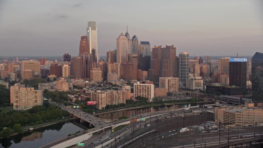A stunning aerial footage captures the vibrant downtown Philadelphia skyline at sunset as seen from Schuylkill River during the spring
