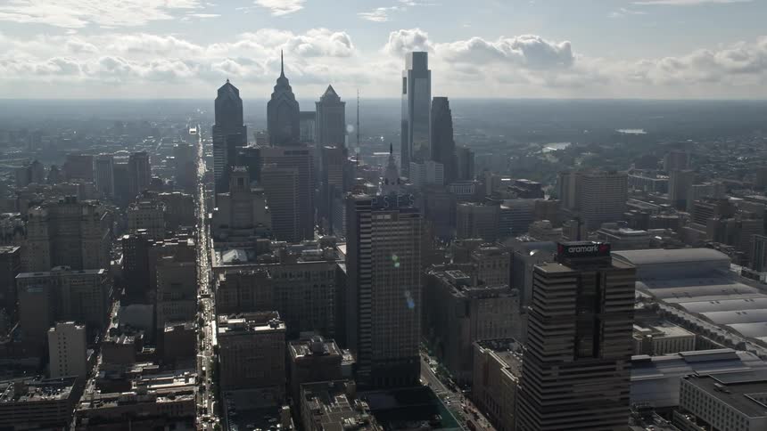 Aerial shot of downtown Philadelphias high rise buildings and towers amidst a hazy day skyline