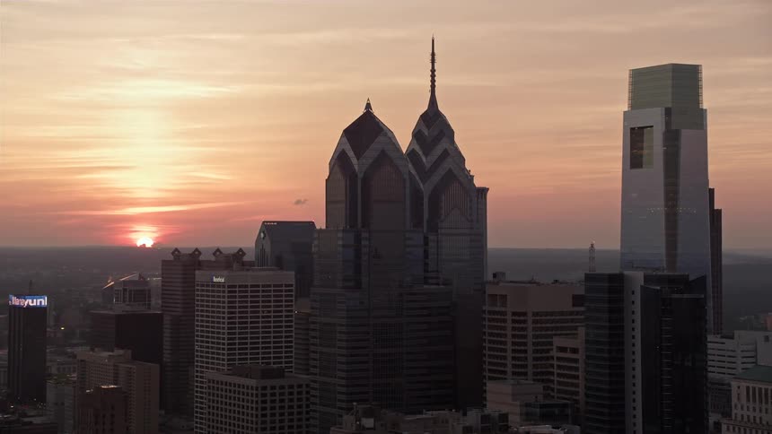 Aerial footage capturing the sunset over the One and Two Liberty Place buildings in downtown Philadelphia