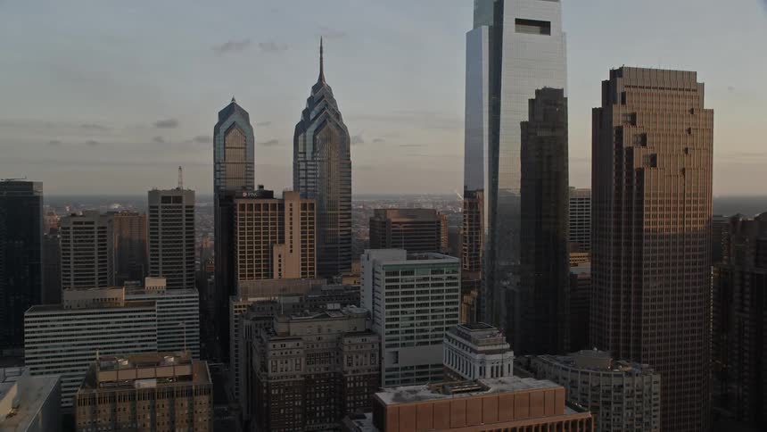 A stunning aerial video clip showcasing the breathtaking skyline of Philadelphias downtown area during sunset featuring tall skyscrapers and modern buildings