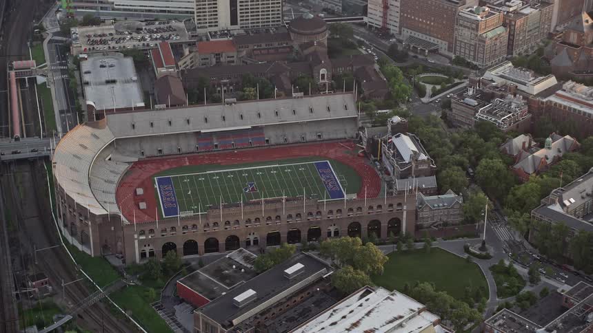 Aerial of a football stadium in the middle of a metropolis city