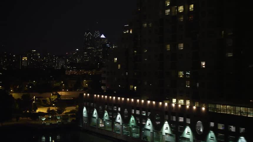 A stunning aerial view of Downtown Philadelphia at night with a clear sky and reveals The Residences at Dockside condo complex