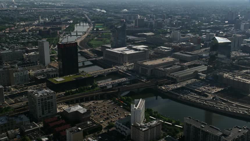 Aerial footage of 30th Street Station and the Main Post Office across the Schuylkill River in Philadelphia