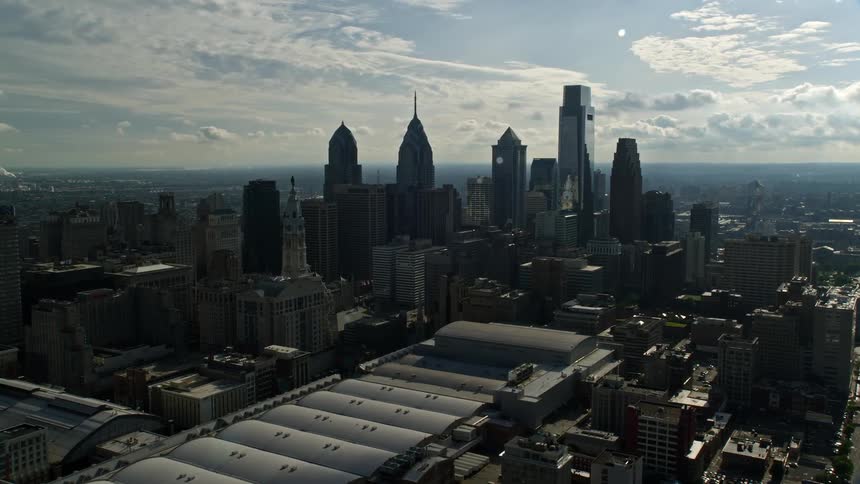 Approaching the high-rise buildings and Pennsylvania Convention Center in the bustling metropolis of Downtown Philadelphia seen from a stunning aerial 