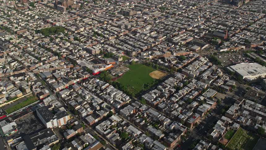 Blocks of apartment buildings surround baseball field