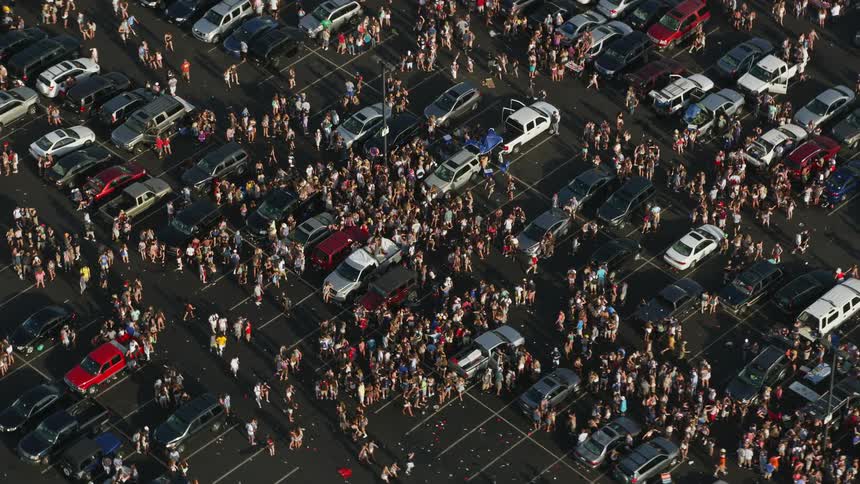 Aerial footage of a large crowd gathering in a parking lot near Campbells Field in Camden New Jersey during a sunny day