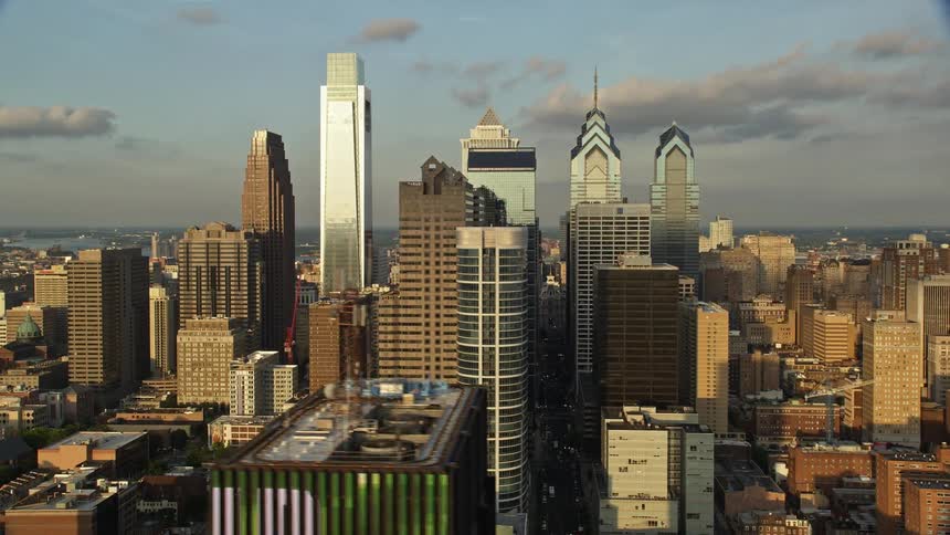 Aerial footage captures the majestic towers and skyscrapers of Downtown Philadelphia during a beautiful sunset